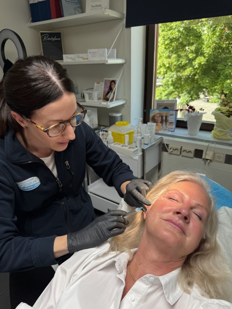 Sjuksköterska på Växjö Medical Center AB utför Sunekos-behandling i ansiktet på patient i behandlingsrum.